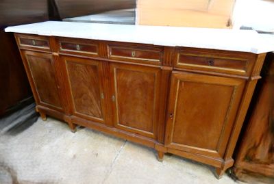a wooden cabinet with a marble top in a room