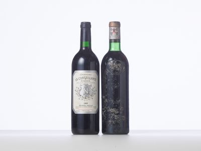 two bottles of wine sitting next to each other on a table