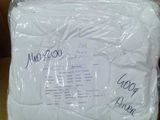 a white pillow that is wrapped in plastic on a table