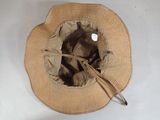 a straw hat with a brown ribbon around the brim of it