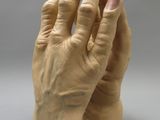 a clay sculpture of a person ' s hands on a table