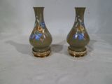 two vases that are sitting on a white surface