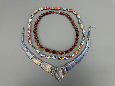 a close up of a necklace and bracelet on a table