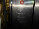 a large stainless steel refrigerator in a dark room