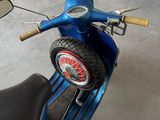 a blue scooter parked inside of a garage