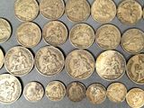 some of the coins have been placed on a table for display