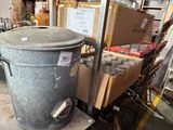 a large metal trash can sitting on a cart in a warehouse