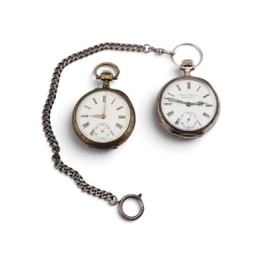 two old pocket watches on a chain on a white surface