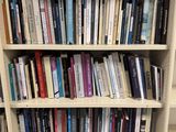 a bookshelf with many books on it in a library
