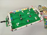 a table with a soccer game and a book on it