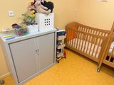 a crib with a stuffed animal on top of it in a room