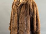 a close up of a fur coat on a mannequin stand