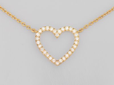 a diamond heart necklace on a gold chain