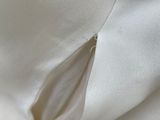 a close up of a white shirt with a zipper on it