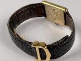 an image of a wrist watch with a gold d on it