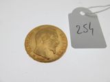 a close up of a gold coin with a price tag on it