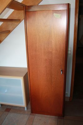 a wooden door and stairs in a small room