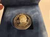 someone is holding a coin with a picture of a man on it