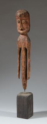 une photo d'une sculpture en bois représentant un homme posé sur un bloc