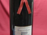 a bottle of wine with a red ribbon on it