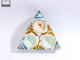 une assiette en forme de triangle sur laquelle est représenté un homme