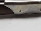 a close up of a gun on a table with a white background