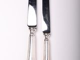 two knives that are sitting next to each other on a table