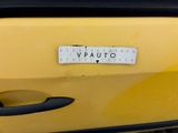 a sticker that says vauto on the side of a yellow car
