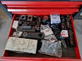 a red tool box filled with assorted items