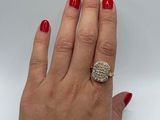 an image of a woman ' s hand with red nails and a gold ring