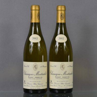two bottles of wine sitting on top of a table next to each other