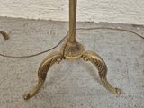 a small table with a glass top and a gold base