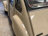 a car that is parked in a garage with other cars in the background