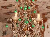 a chandelier in the middle of a room with a wallpapered ceiling