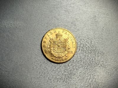a close up of a coin on a table with a black background