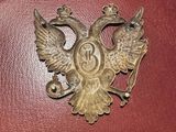 a metal bird with a crown on it ' s back
