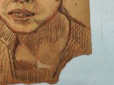 a drawing of a boy with a hat on a piece of paper