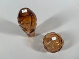 two brown glass vases sitting on a white surface