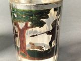 a shot glass with a picture of a man and a dog on it