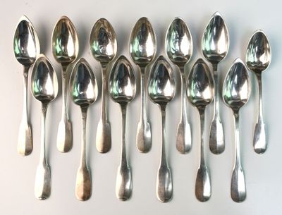 six spoons are lined up in a row on a white surface