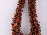 a close up of a necklace on a white surface