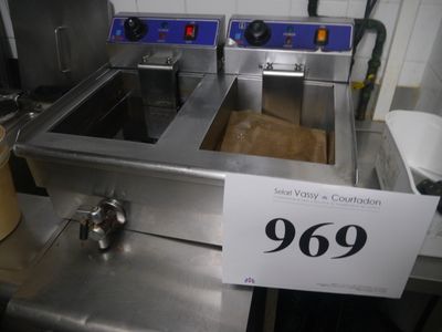 a picture of a commercial kitchen with stainless steel counter tops