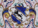 a plate with a coat of arms and a horse on it