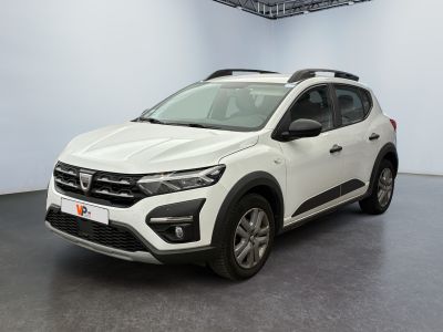 the white car is parked in a room with a black floor