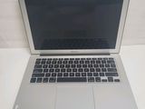 an open laptop computer sitting on top of a white table