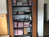 a book shelf with many books on it in a room