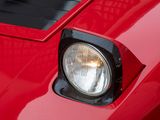 a close up of a car ' s headlight on a red car