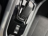 a close up of a car ' s center console with a cell phone in it
