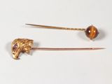 pair of gold tone hair pins with a tiger head and a tiger ' s head