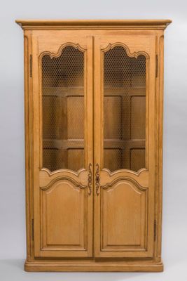 a wooden cabinet with glass doors and a door handle